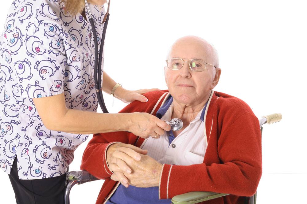 Nurse helping an elderly patient with vitals