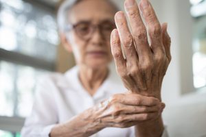 Elderly Woman Holding Her Wrist Showing Her Hand in Pain from Arthritis