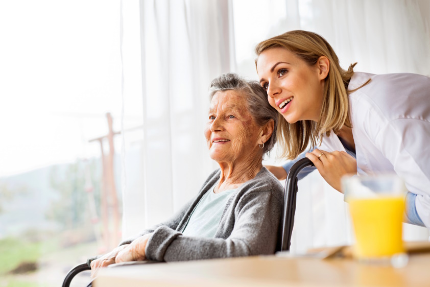 family member showing elderly patient something out the window