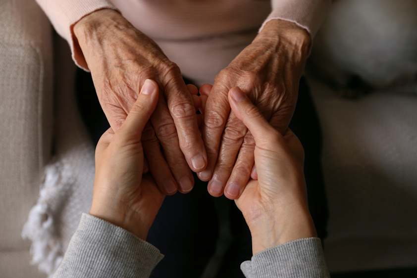 someone holding an older person's hands