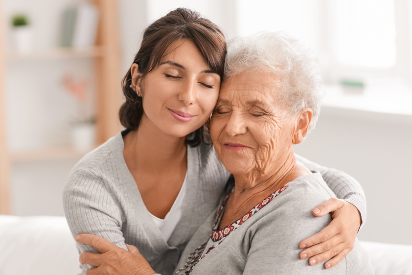 woman hugging an older lady