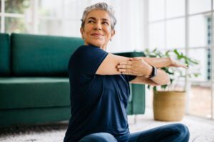 senior woman stretching at home