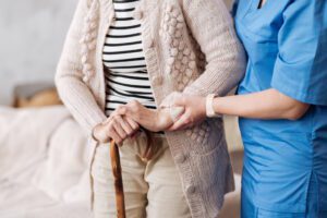 home nurse helping senior woman walk