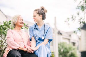 home nurse with senior woman outside