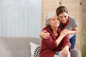 home caregiver hugging senior woman