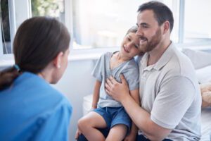 home nurse talking with child and dad