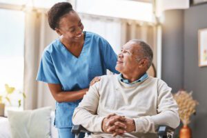 home health nurse with senior man in wheel chair