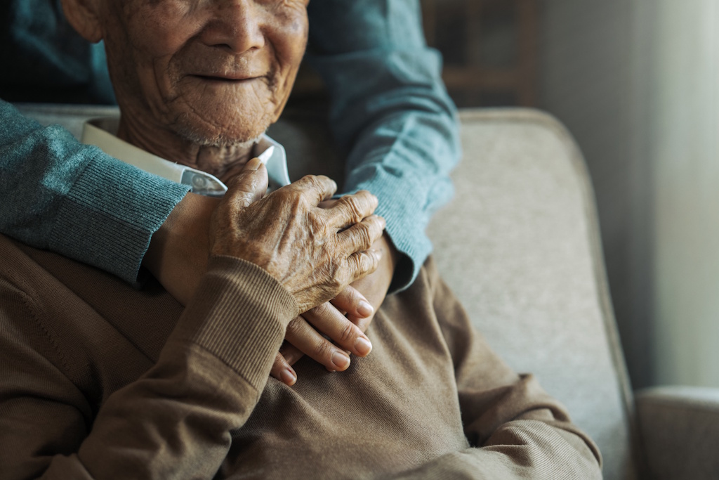 senior man hugging family member