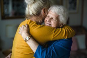 woman hugging elderly mother