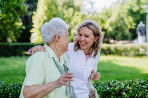 caregiver walking with senior woman