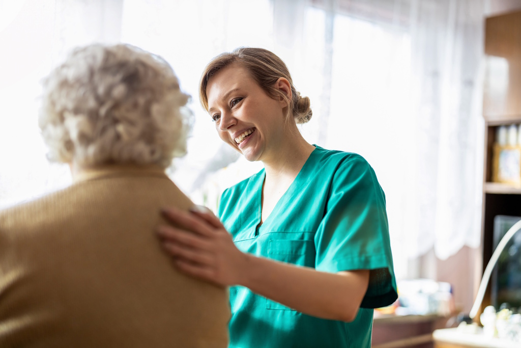 home health nurse talking to senior woman