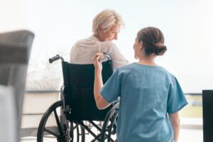home health nurse with woman in wheelchair