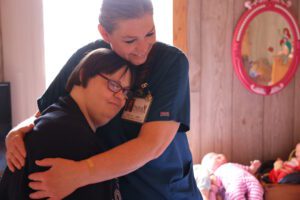 home health nurse hugging patient