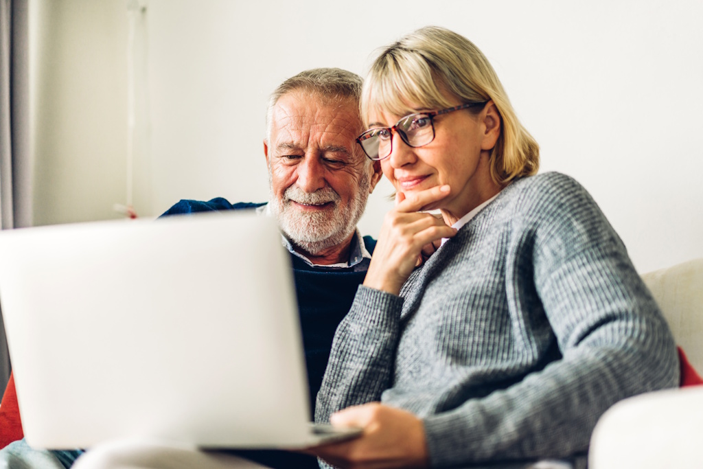senior couple reviewing medicare options on laptop