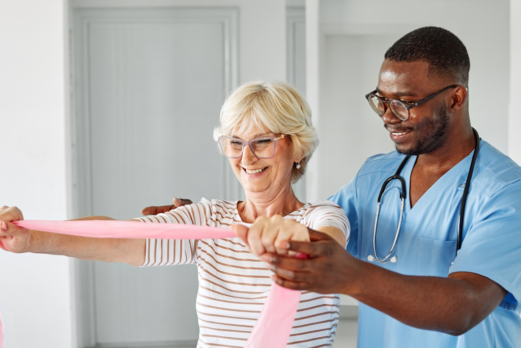 senior woman stretching with physical therapist