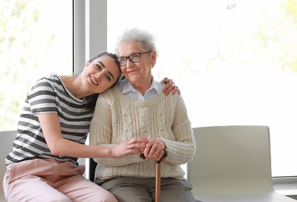 woman hugging elderly grandmother