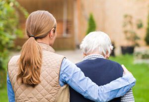 woman hugging an older woman outside