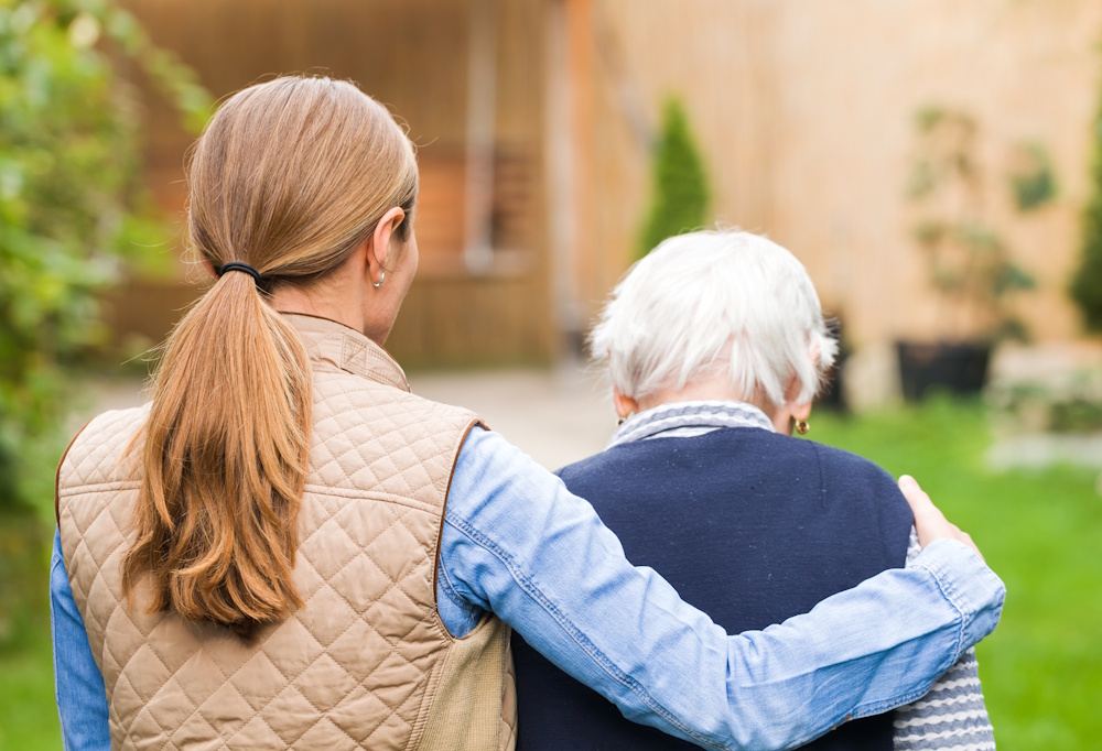 woman hugging an older woman outside