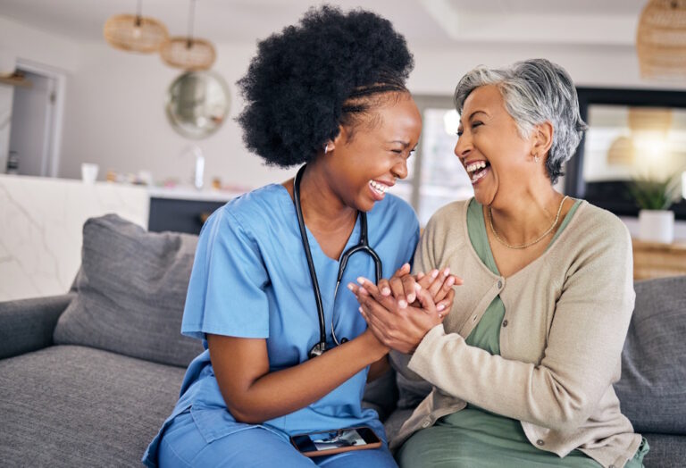 caregiver laughing with a patient