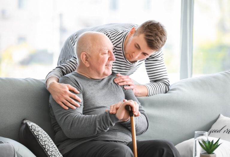 son helping father during home hospice