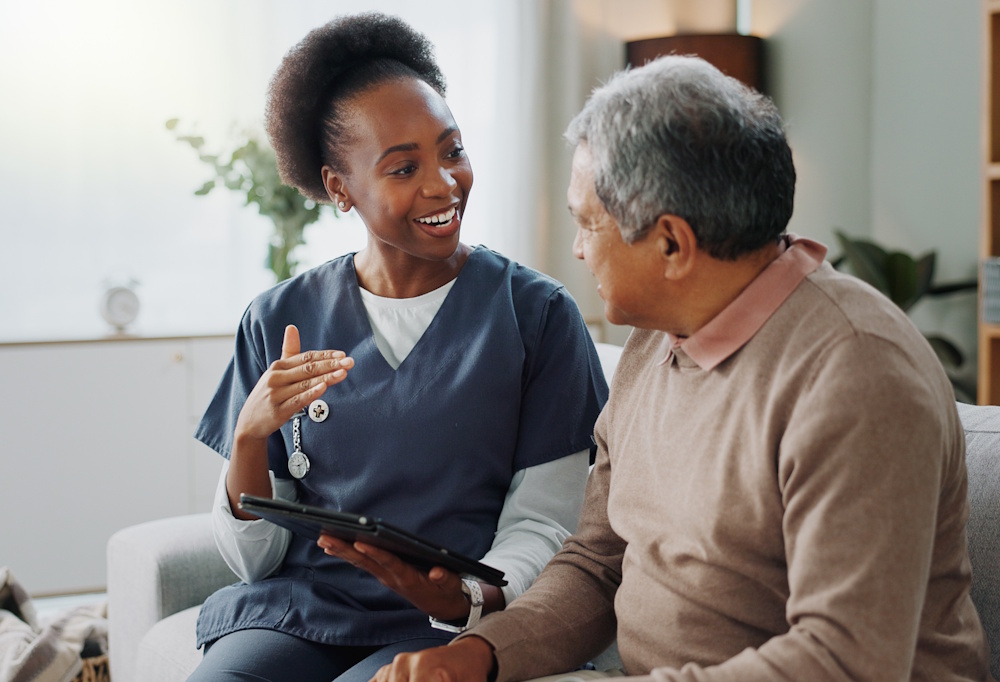 home caregiver talking to senior man